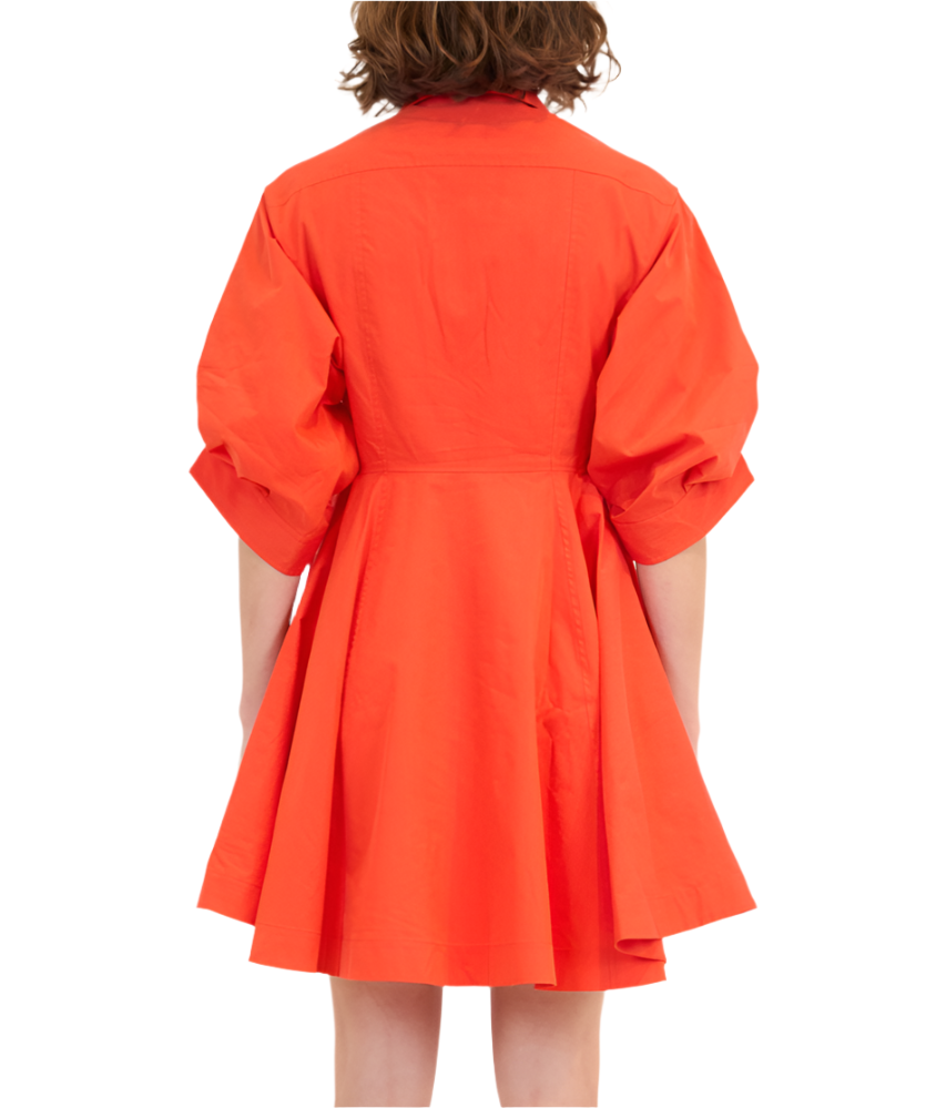 Back view of someone wearing the Simkhai Jazzie Mini Dress, an orange ensemble made from 100% cotton with elbow-length sleeves and a flared poplin skirt.