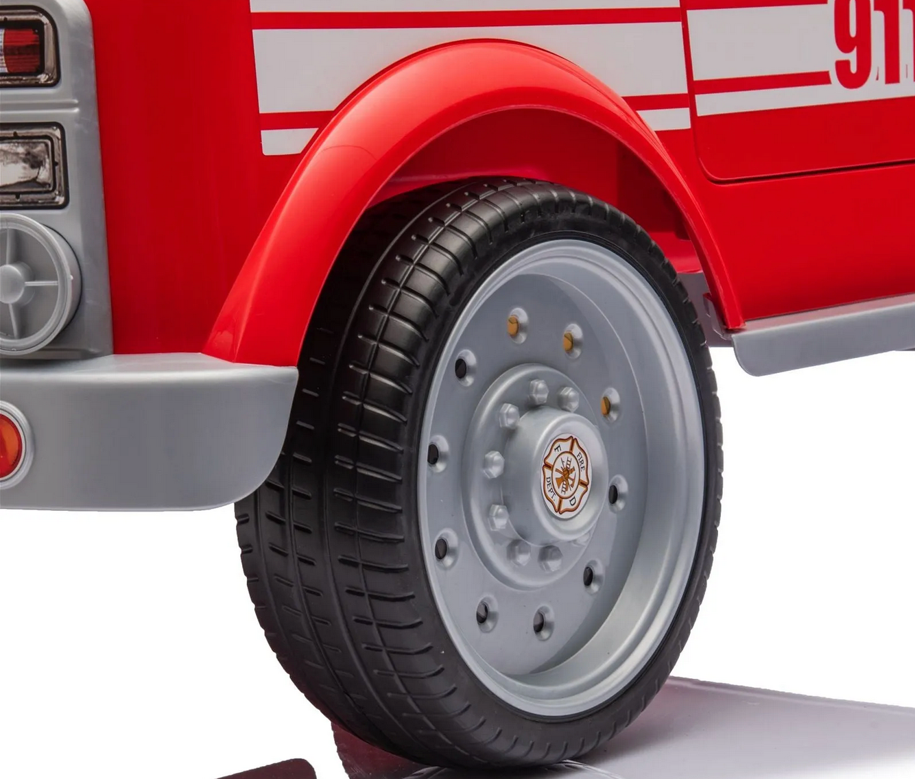 Close-up of the rear wheel and fender of the Freddo Fire Truck, showing a silver and black wheel, red body with side stripes, and glimpses of interactive features for enhanced play.