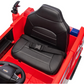 A close-up of the black seat with seatbelt inside the Freddo Fire Truck ride-on, featuring part of the steering wheel and dashboard—a perfect toy for aspiring young heroes.