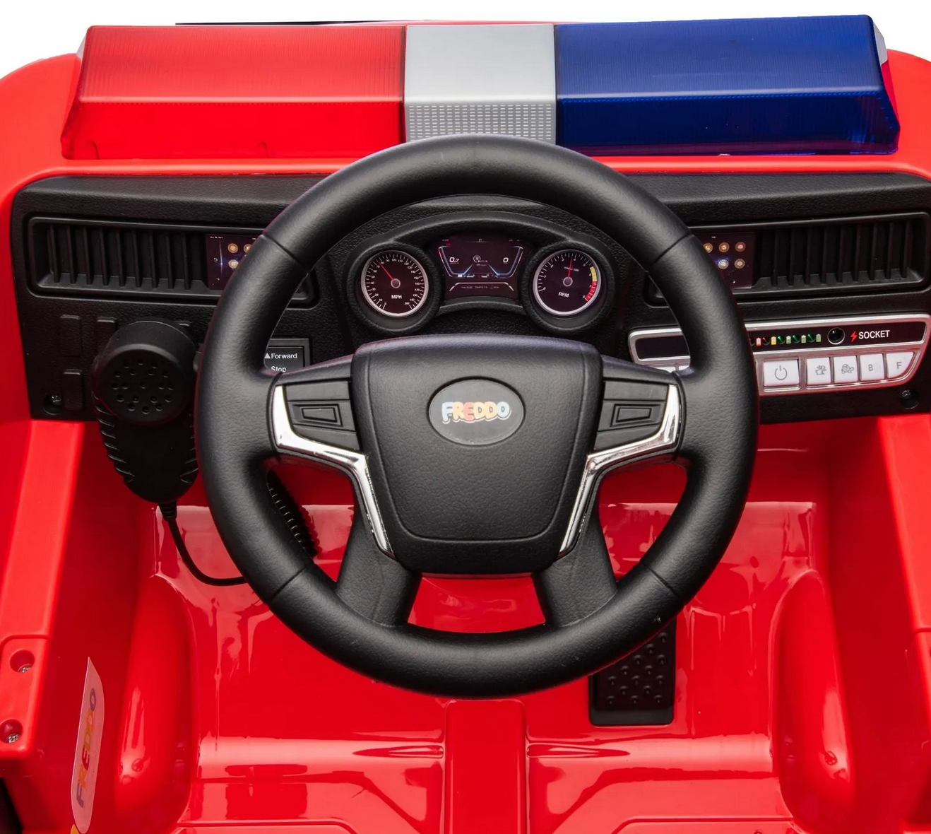Close-up view of the Freddo Fire Truck dashboard with steering wheel, control buttons, speedometer dials, and a red and blue light bar—perfect interactive features for any kids hero toy collection.