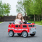 A young girl rides the Freddo Fire Truck on a paved road, surrounded by green trees and a wooden fence, feeling like a true hero.