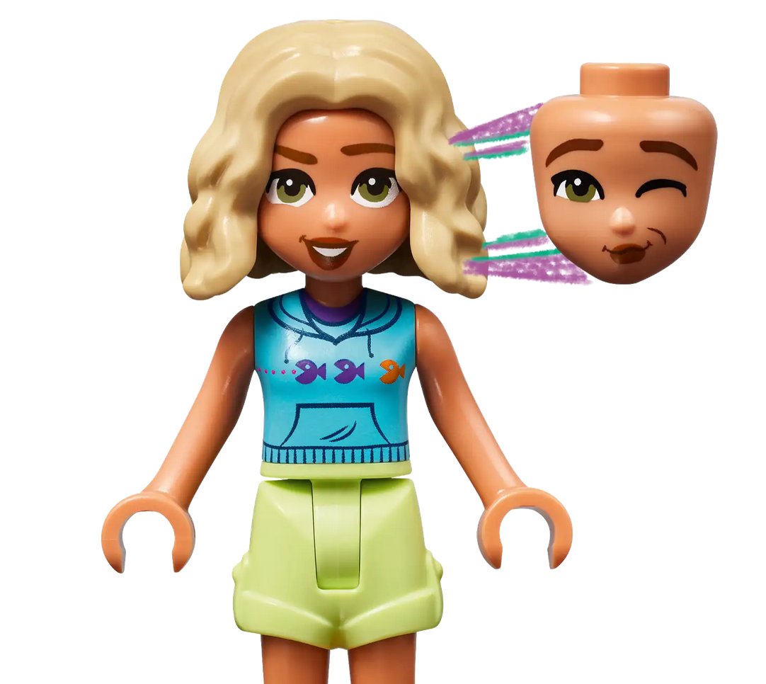 Discover the perfect addition to your LEGO® Friends Beach Smoothie Stand or any LEGO Friends play set, featuring a Legos - Toyhouse figure with a blue top and green shorts. This delightful figure comes with two interchangeable heads: one smiling with both eyes open and the other winking.