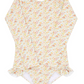 Minnow Girls' Rashguard One Piece, featuring a floral pattern with long sleeves, ruffled leg openings, and a rashguard design, displayed flat on a white background.