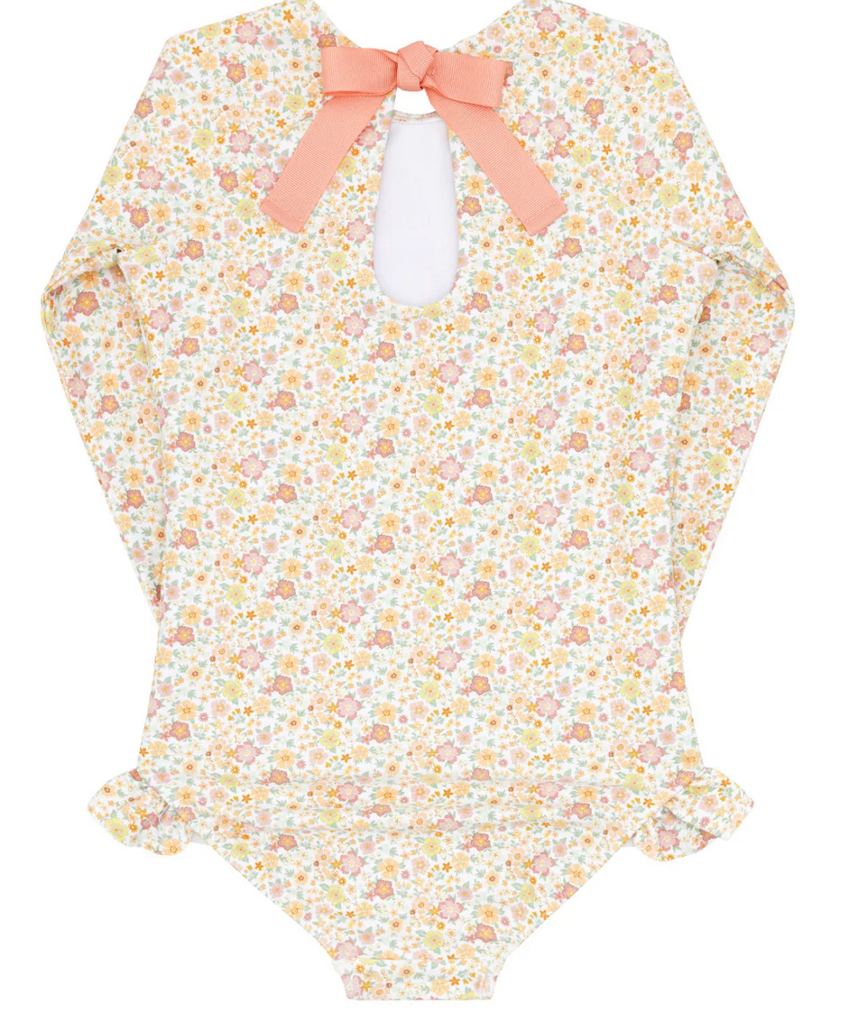 Minnow's Girls' Rashguard One Piece features a floral pattern with long sleeves, a grosgrain ribbon bow at the back, and ruffled leg openings, providing sun-safe protection.