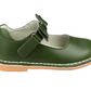 The L'Amour Iris Bow Strap Mary Jane by L'Amour Shoes in green, featuring a Velcro strap, white interior, and tan sole, perfectly captures the essence of fall fashion.