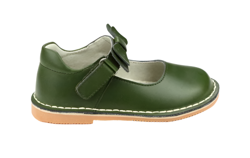 The L'Amour Iris Bow Strap Mary Jane by L'Amour Shoes in green, featuring a Velcro strap, white interior, and tan sole, perfectly captures the essence of fall fashion.