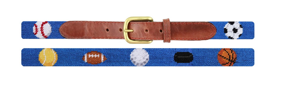 The SMB Children's Sports Belt by Smathers & Branson showcases a blue strap with brown Italian leather accents, a gold buckle, and hand-stitched needlepoint sports balls.