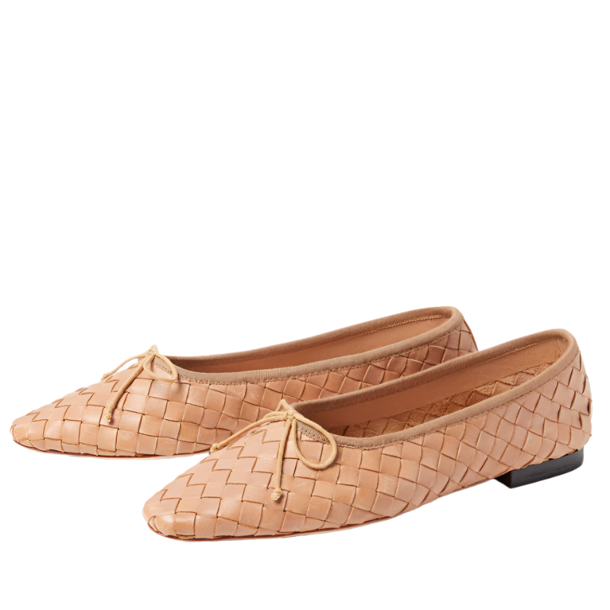 The Loeffler Randall Landry Woven Flat, in a beige hue, showcases bows on the front, low black heels, and a padded leather footbed—perfectly displayed on a white background.