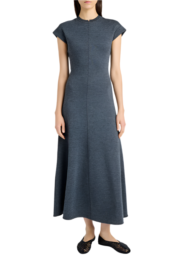 A person wearing a Proenza Schouler White Label Melanie Dress in Souffle Cotton, featuring a grey, short-sleeved A-line silhouette, paired with black woven shoes, stands against a white background.