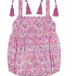 The Mer St Barth Zoe Romper by Mer is a perfect summer staple with pink and purple patterns, shoulder ties, tassel detailing, and two charming adjustable straps with bows.