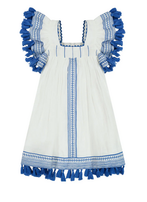 The Girls' Serena Dress by Mer is a white dress featuring blue tassels, trim, a square neckline, and ruffled sleeves with whimsical embroidery. Perfect for special occasions, this ensemble exudes charm and elegance.