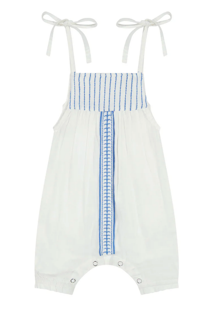 The Mer St Barth Marley Baby Romper by Mer is made of white cotton gauze with blue vertical stripes, whimsical embroidery, adjustable tie straps, and snap closures at the crotch.