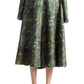 A woman in the Altuzarra Varda Skirt, featuring a green marbled floral print and knee-length midi silhouette, paired with a matching long-sleeve top and black low-heeled shoes.