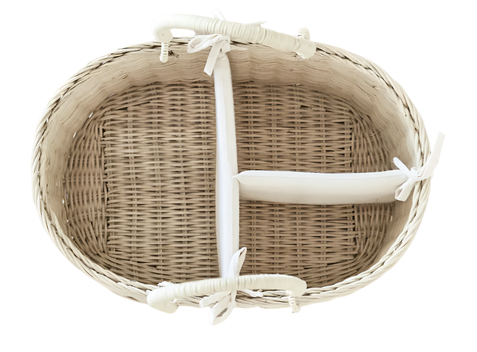 Top view of the BSavannah Diaper Caddy by Bebe Bask shows its woven wicker design with a white fabric lining. Made from eco-friendly rattan, it features three compartments separated by removable foam dividers for versatile storage.