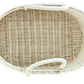 Top view of a BSavannah Diaper Caddy by Bebe Bask, an eco-friendly, oval-shaped rattan wicker basket with two handles in a natural light color. Ideal for diaper storage or household organization.