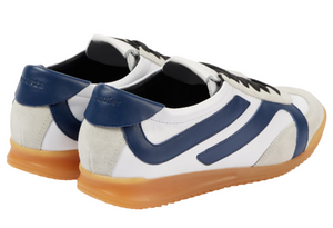 The Proenza Schouler Track Sneakers are white nappa leather with blue accents, gum soles, and a rear embossed logo.