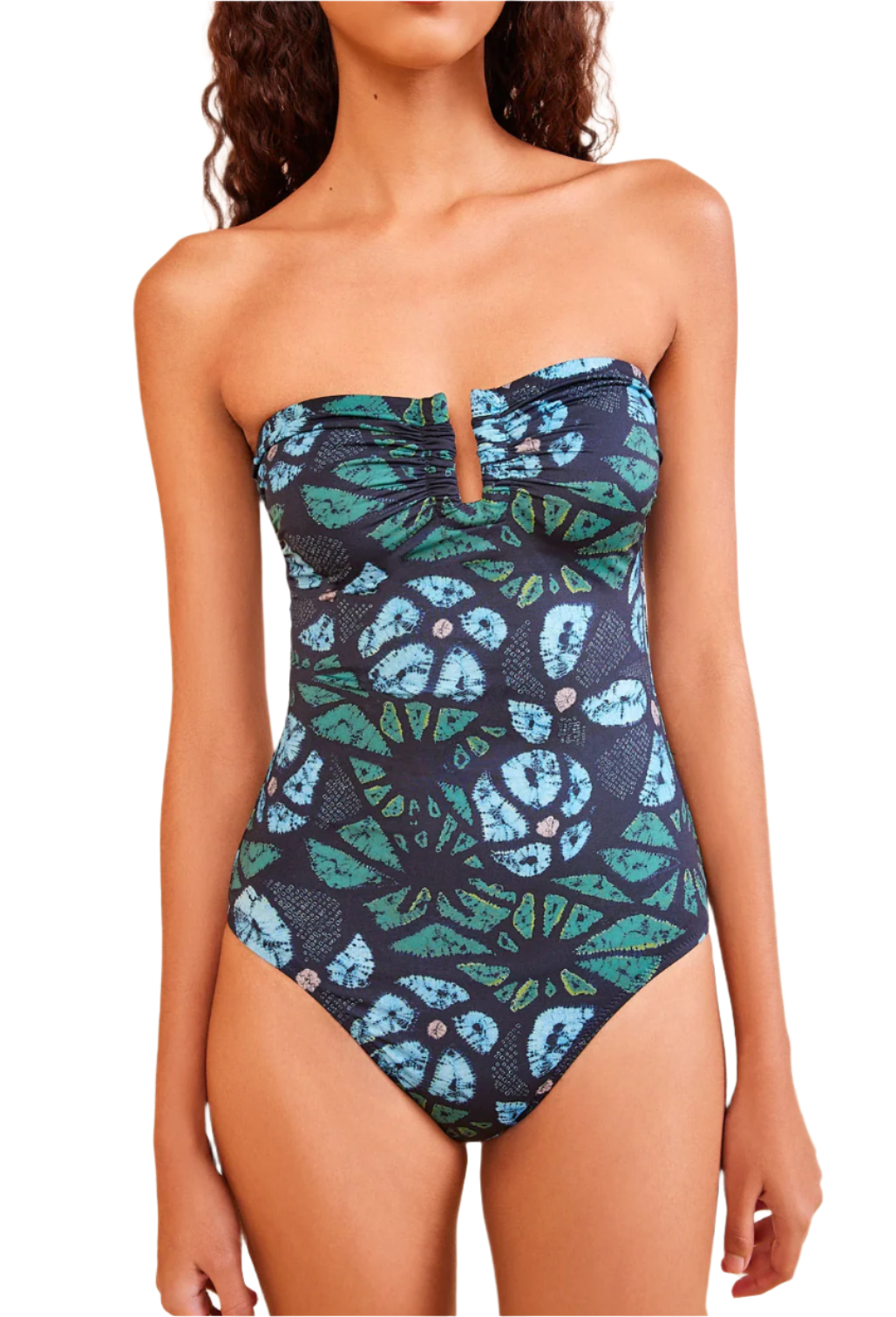 Model wearing the Ulla Johnson Monterey Maillot One Piece, a strapless swimsuit with a blue and green abstract floral print, subtle sweetheart neckline, and full coverage bottom.
