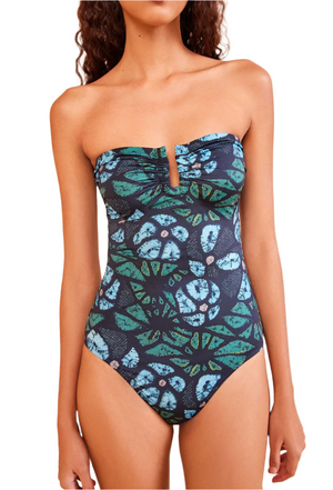 Model wearing the Ulla Johnson Monterey Maillot One Piece, a strapless swimsuit with a blue and green abstract floral print, subtle sweetheart neckline, and full coverage bottom.