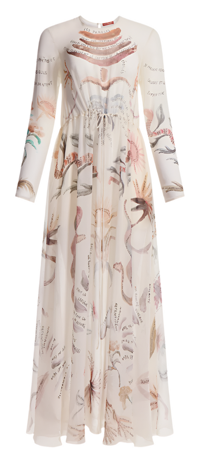 The Altuzarra Sybbeline Dress is a long-sleeved sheer silk gown with a sophisticated high collar and maxi hem, adorned with intricate botanical illustrations resembling delicate tattoos.