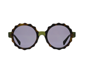 The Lily Sunglasses by Jimmy Fairly feature round, wavy dark tortoiseshell acetate frames with green accents, light purple lenses, and durable metal hinges, displayed against a white background.