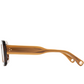Side view of Ily Sunglasses by Jimmy Fairly, featuring amber-colored, rectangular cellulose acetate frames with black rims, metal hinges, and two small holes at the temple arm ends, displayed on a white background.