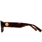 The Jimmy Fairly Meli Icons Sunglasses are pictured from the side, showcasing their butterfly tortoiseshell frame and a gold circular emblem on the arm near the hinge.