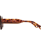 Side view of Portofino Sunglasses by Jimmy Fairly, featuring a hexagonal, tortoiseshell-patterned frame with two metal rivets on the arm, made from recycled acetate, shown against a white background.