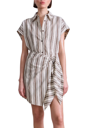 A woman wears the Apiece Apart San Vito Sarong Dress, a short-sleeve, button-up mini dress with a tied waist and vertical beige and brown stripes for a flattering fit.