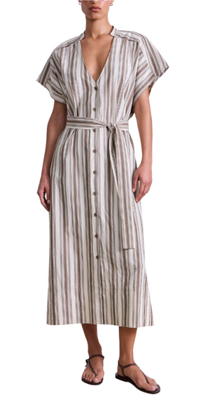 A person wears the Apiece Apart Isola Caftan Dress—beige and white vertical stripes, short sleeves, button-down, matching belt—with black sandals for an effortlessly chic vacation look, ideal over a caftan or stylish bathing suit.