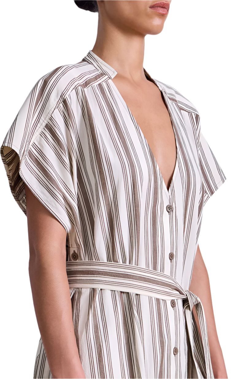 A person wears the Apiece Apart Isola Caftan Dress, featuring short sleeves, stripes, a V-neck, and a matching waist tie, styled with sandals.