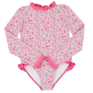 The Beaufort Bonnet Company's Baby Girls and Girls' Sarasota Surf Suit features long sleeves, a pink floral design, ruffled collar and leg openings, pink lace trim, and built-in sun protection for stylish comfort.