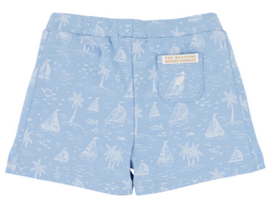 The Beaufort Bonnet Company Baby Boys' and Boys' Shaefer Shorts in light blue pima cotton, with white sailboat, palm tree, and bird print, and a small logo label on the back pocket.