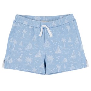 The Beaufort Bonnet Company’s Baby Boys' and Boys' Shaefer Shorts feature soft pima cotton in light blue, a white drawstring, and a charming pattern of sailboats, palm trees, birds, and fish.