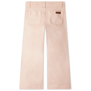 The Girls' Gersande Flared Jeans in Organic Cotton by Bonpoint are shown from the back in light pink, high-waisted with a flared leg, two rear pockets, and a small brown patch on the right pocket.
