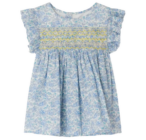 The Bonpoint Girls' Fidji Smocked Blouse, made with Liberty Fabrics, features a light blue floral print, short ruffled sleeves, yellow and blue hand-embroidered smocking across the chest, and a gathered skirt.