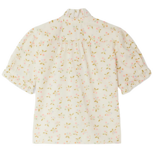 The Bonpoint Girls' Cindy Blouse features a cream color, organic cotton fabric, cherry print, ruffled cuffs, and a gathered collar, shown flat with the back facing up.