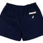 The Beaufort Bonnet Company Boys' Sheffield Shorts in navy blue feature an elastic waistband, a back pocket with a white bird icon and a label above it, all in the brand's signature Sheffield Shorts style.