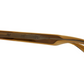 Side view of The Ezra eyeglass frames by Jimmy Fairly, crafted from recycled brown translucent acetate with engraved temple detailing, shown against a white background.