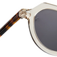Close-up of The Hometown sunglasses by Jimmy Fairly, featuring clear beige cellulose acetate frames, dark lenses, and a tortoiseshell-patterned temple arm.