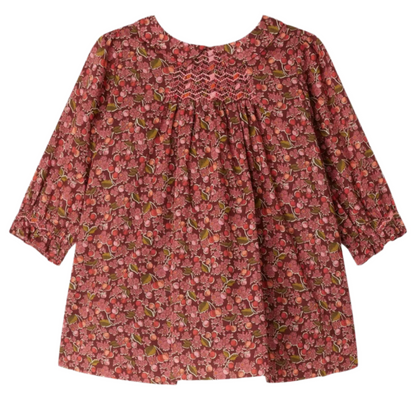 The Bonpoint Baby Girls' and Girls' Juju Smocked Dress, made with Liberty Fabrics in organic cotton, features long sleeves, chest smocking, gathered fabric, and a red, pink, and green floral print.