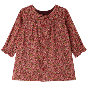 The Bonpoint Baby Girls' and Girls' Juju Smocked Dress is made with Liberty Fabrics in organic cotton, featuring long sleeves, a red floral print, gathered cuffs, and a round neckline.