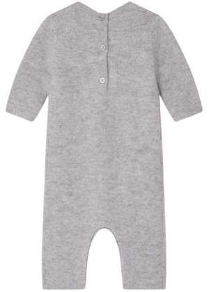 The Bonpoint Baby Boys' Tinoe All in One Outfit is a grey knit long-sleeve onesie with snap buttons down the back, closed feet, and an embroidered dog detail, shown laid flat with the back facing up.