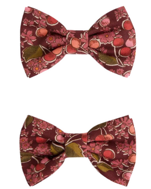 Two Tutu Hair Clips by Bonpoint, crafted from Liberty fabric with maroon, pink floral and leaf patterns, are displayed separately on a white background.