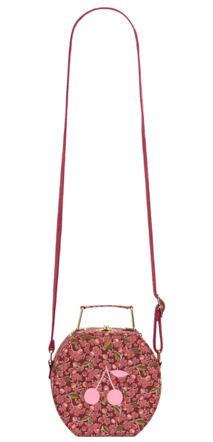 The Jadore Suitcase-Style Bag by Bonpoint features red Liberty fabric, a long strap, short handle, and a charming cherry design on the front.