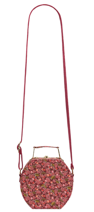 The Bonpoint Jadore suitcase-style bag features red Liberty fabric, with a top handle and long adjustable shoulder strap, set against a white background.