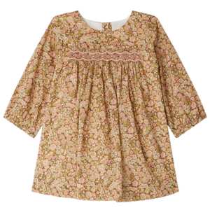 Bonpoint’s Baby Girls’ and Girls’ Félicie Smocked Dress, crafted with Liberty fabric, features long sleeves, a pink and beige floral pattern, a gathered waist, and decorative smocking on the chest.