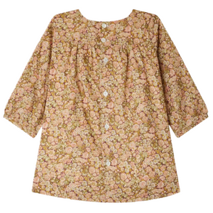 The Bonpoint Baby Girls’ and Girls’ Félicie Smocked Dress, made with Liberty fabric, features a pink and brown floral motif.