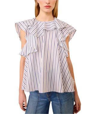 A woman wears the Ulla Johnson Amaia Top, a blue striped blouse with wide ruffled sleeves in soft cotton shirting, paired effortlessly with blue jeans.