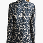 A person with light brown hair models the Altuzarra Chika Top, a long-sleeve black and white abstract patterned silk blouse with a concealed button front, shown from the back against a white background.