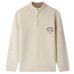 The Bonpoint Boys' Gert Cashmere Sweater features a beige design with a trucker collar and blue "Bonpoint Maison Atelier" embroidery on the left chest.